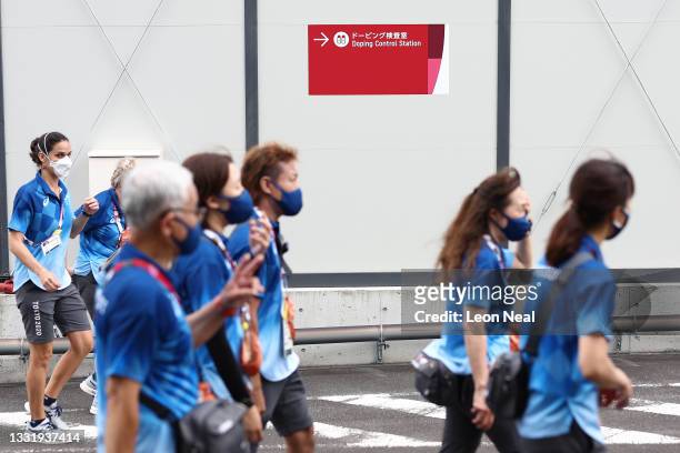 Group of Tokyo 2020 volunteers walk past a doping control station, near to the Izu Velodrome cycling venue on day 10 of the Tokyo Olympic Games on...