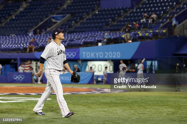 Masahiro Tanaka of Team Japan walks off the mound after leaving the game in the fourth inning against Team United States during the knockout stage of...