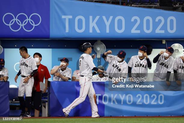 Hayato Sakamoto of Team Japan returns to the dugout after scoring in the third inning against Team United States during the knockout stage of men's...