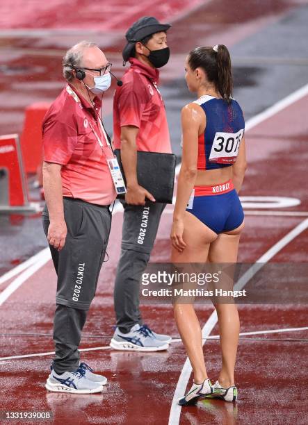 Amalie Iuel of Team Norway talks to officials as rains falls prior to the Women's 400 metres hurdles semi finals on day ten of the Tokyo 2020 Olympic...