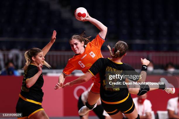 Laura van der Heijden of Team Netherlands shoots over the top of Tatjana Brnovic of Team Montenegro as Majda Mehmedovic of Team Montenegro look on...