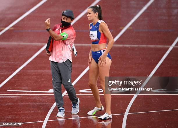 Amalie Iuel of Team Norway talks to an official as rains falls prior to the Women's 400 metres hurdles semi finals on day ten of the Tokyo 2020...