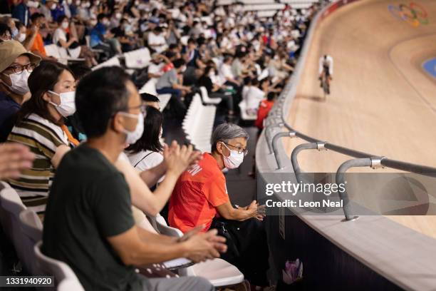 Spectators watch from the stands as athletes take part in the Men's Team Pursuit Qualifying at Izu Velodrome on August 02, 2021 in Izu, Shizuoka,...