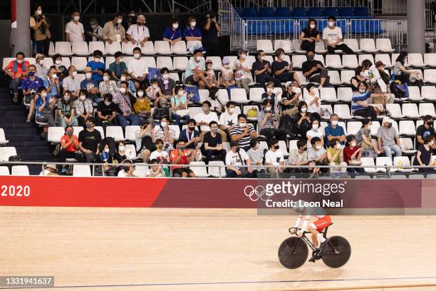 Spectators watch from the stands as a member of Team Poland takes part in the Women's Team Sprint at Izu Velodrome on August 02, 2021 in Izu,...