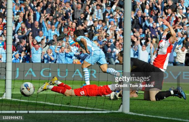 Sergio Aguero scores the late winning goal for Manchester City as QPR players show their dejection during the Manchester City v Queens Park Rangers...