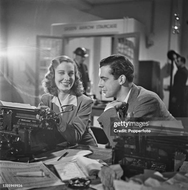 Irish actress Valerie Hobson , playing the role of fashion journalist Carol Bennett, and English actor Richard Greene , playing the role of war...