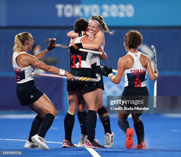 Grace Balsdon of Team Great Britain celebrates with teammates Hannah Martin, Hollie Pearne-Webb and Anna-Frances Toman after scoring their team's...