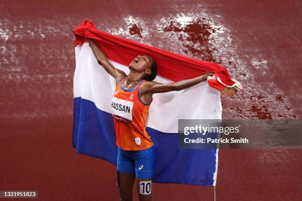 Sifan Hassan of Team Netherlands celebrates as she walks the track with her countries flag after winning the gold medal in the Women's 5000 metres...