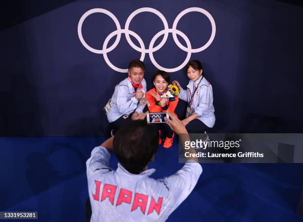 Mai Murakami of Team Japan poses with her coaches after winning bronze medal in the Women's Floor Final on day ten of the Tokyo 2020 Olympic Games at...