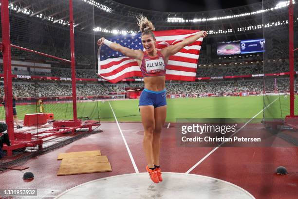 Valarie Allman of Team United States celebrates with her countries flag after winning the gold medal in the Women's Discus Final on day ten of the...