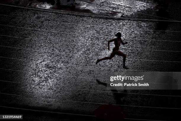 Lea Sprunger of Team Switzerland competes in the rain during the women's 400 metres semifinal on day ten of the Tokyo 2020 Olympic Games at Olympic...