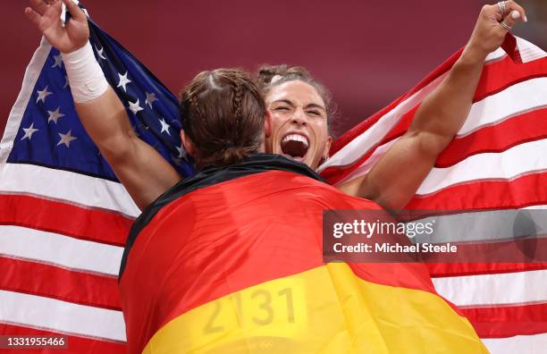 Silver medalist, Kristin Pudenz of Team Germany and gold medalist Valarie Allman of Team United States celebrate with their respective flags...
