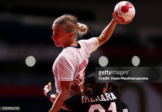 Stine Bredal Oftedal of Team Norway shoots at goal while under pressure from Ayaka Ikehara of Team Japan during the Women's Preliminary Round Group A...