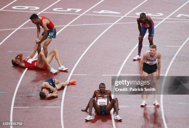 Soufiane El Bakkali of Team Morocco reacts with competitors after winning the gold medal in the men's 3000 metres steeplechase on day ten of the...