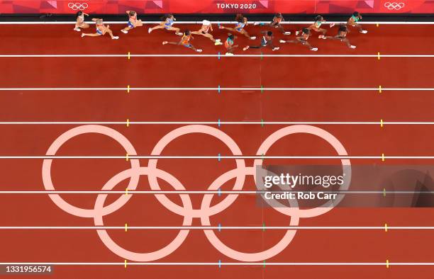 Competitors run past the on track Olympic rings during the Women's 5000 metres Final on day ten of the Tokyo 2020 Olympic Games at Olympic Stadium on...