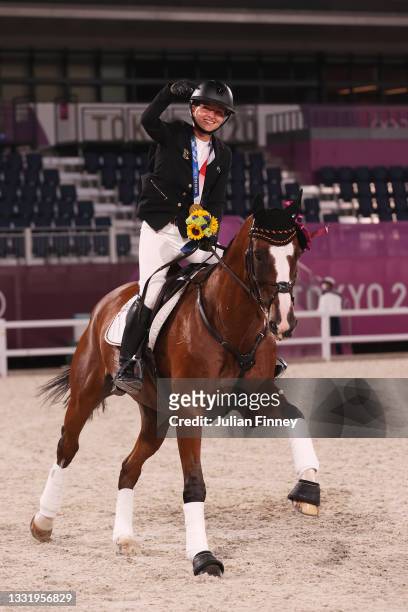 Gold medalist Julia Krajewski of Team Germany riding Amande de B’Neville celebrates with the gold medal after the Eventing Individual Jumping medal...