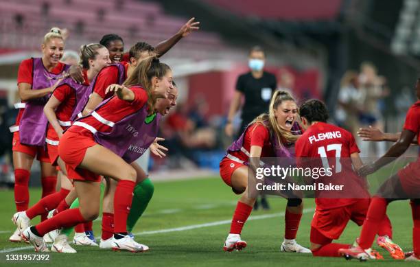 Players of Team Canada celebrate their side's first goal scored by Jessie Fleming of Team Canada during the Women's Football Semifinal match between...