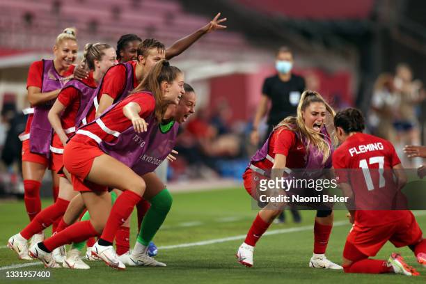 Players of Team Canada celebrate their side's first goal scored by Jessie Fleming of Team Canada during the Women's Football Semifinal match between...
