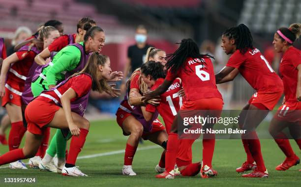 Players of Team Canada celebrate their side's first goal scored by Jessie Fleming of Team Canada during the Women's Football Semifinal match between...