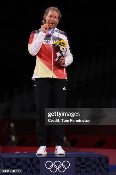 Women's Freestyle 76kg gold medalist Aline Rotter Focken of Team Germany bites her god medal during the Victory Ceremony on day ten of the Tokyo 2020...