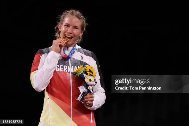 Women's Freestyle 76kg gold medalist Aline Rotter Focken of Team Germany bites her god medal during the Victory Ceremony on day ten of the Tokyo 2020...