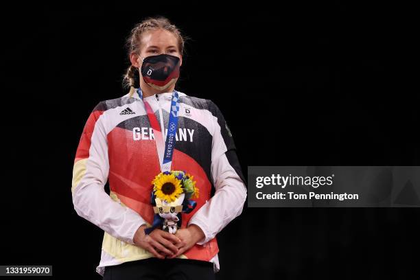 Women's Freestyle 76kg gold medalist Aline Rotter Focken of Team Germany stands for the national anthem during the Victory Ceremony on day ten of the...