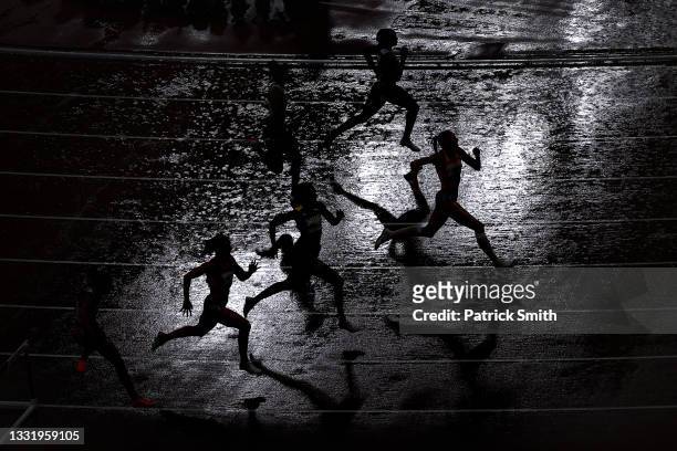Runners compete in the Women's 400 metres hurdles semi finals on day ten of the Tokyo 2020 Olympic Games at Olympic Stadium on August 02, 2021 in...