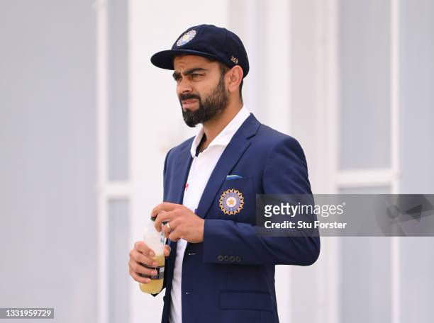 India captain Virat Kohli looks on whilst wearing his whites and blazer ahead of the series trophy photo call after India nets ahead of the First...