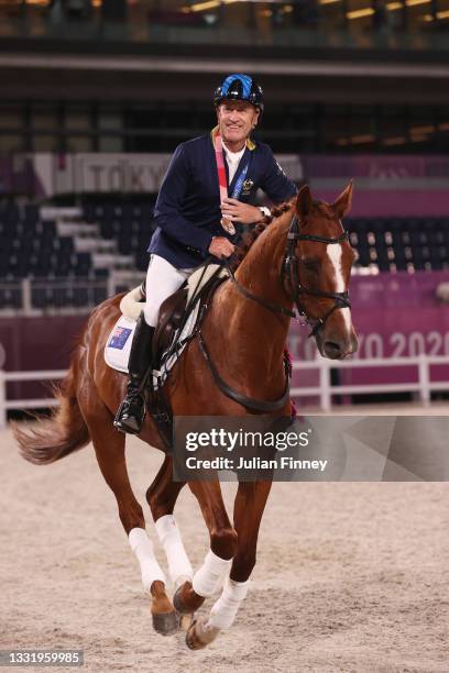 Bronze medalist Andrew Hoy of Team Australia riding Vassily de Lassos celebrates with the bronze medal after the Eventing Individual Jumping medal...