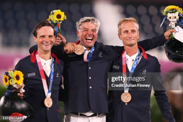 Bronze medalists Nicolas Touzaint, Karim Florent and Christopher Six of Team France pose with their bronze medals during the Eventing Jumping Team...