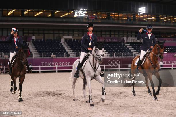 Bronze medalists Nicolas Touzaint, Karim Florent and Christopher Six of Team France celebrate with their bronze medals after the Eventing Jumping...