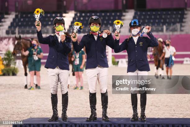 Silver medalists Kevin McNab, Shane Rose and Andrew Hoy of Team Australia pose with their silver medals during the Eventing Jumping Team medal...