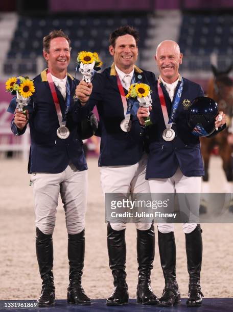 Silver medalists Kevin McNab, Shane Rose and Andrew Hoy of Team Australia pose with their silver medals during the Eventing Jumping Team medal...