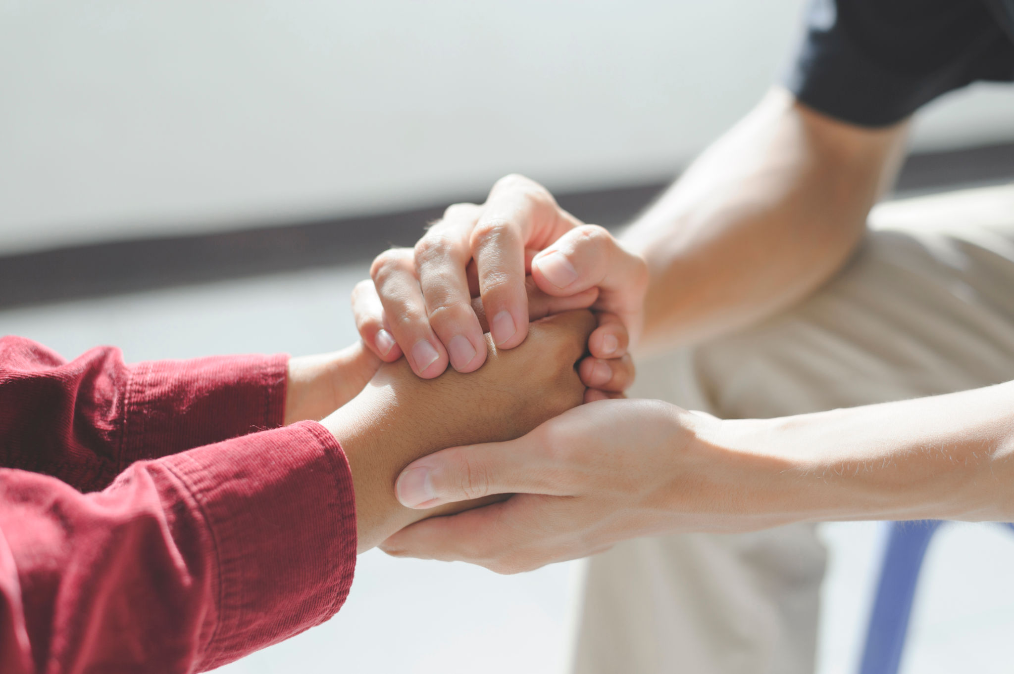 Close-up of man psychologist or psychiatrist sitting and holding hands palm of his woman patient for encouragement. PTSD Mental health concept, Close-up of man psychologist or psychiatrist sitting and holding hands palm of his woman patient for encouragement. PTSD Mental health concept,