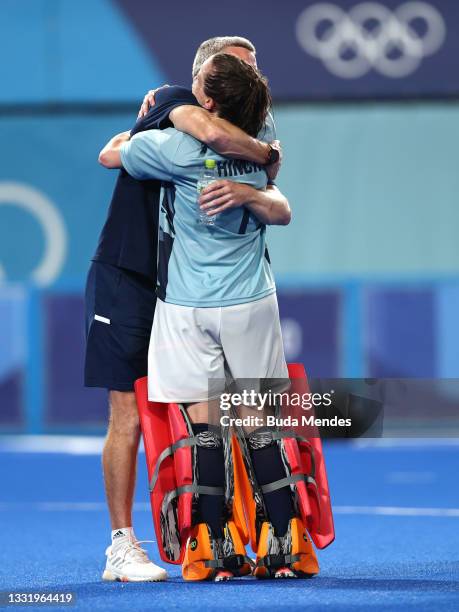 David Ralph, Head Coach of Team Great Britain embraces Madeleine Claire Hinch of Team Great Britain, following the penalty shootout, celebrating...