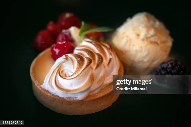 beautiful artistic meringue lemon pie with mint, ice cream and strawberries - maräng bildbanksfoton och bilder