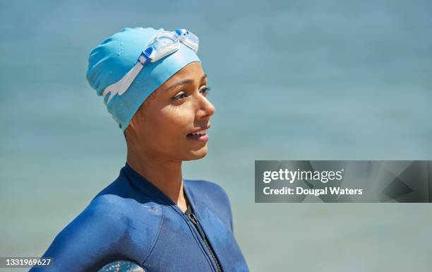 confident sea swimmer at beach, portrait. - swimming cap stock pictures, royalty-free photos & images