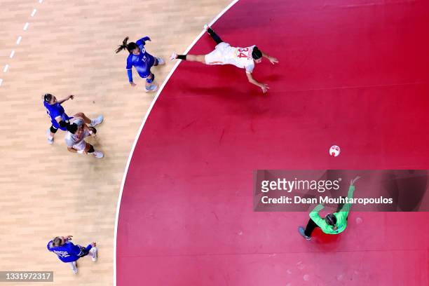 Alicia Fernandez Fraga of Team Spain shoots at goal as Anna Sedoykina of Team ROC looks to save during the Women's Preliminary Round Group B handball...