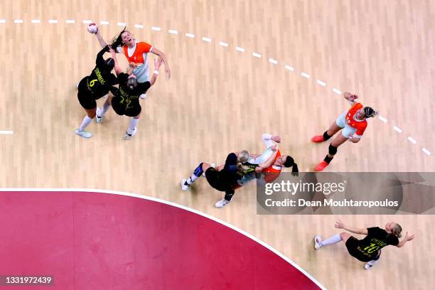 Szandra Szollosi-Zacsik of Team Hungary is challenged by Carin Stromberg and Kristin Thorleifsdottir of Team Sweden during the Women's Preliminary...