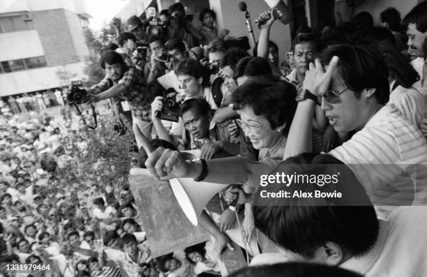 Presidential candidate Corazon Aquino gives the laban sign during a rally at Makati Municipal Hall where she called for a national non-violent action...