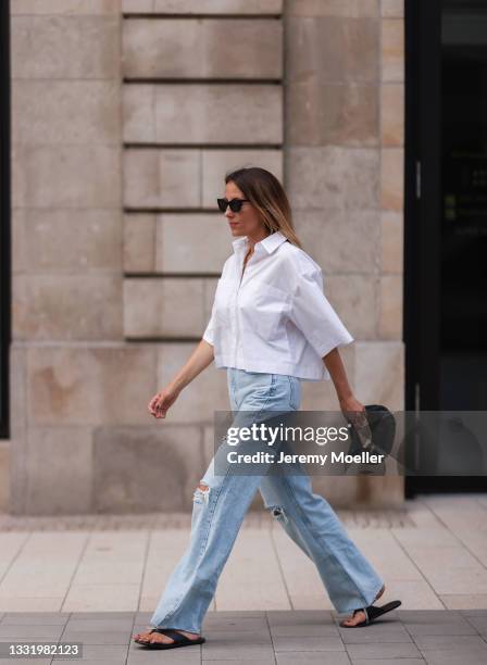 Elise Seitz wearing a white Soho Studios blouse, Zara wide leg pants and black Bottega Veneta bag on July 30, 2021 in Hamburg, Germany.