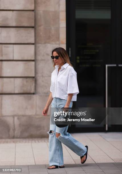 Elise Seitz wearing a white Soho Studios blouse, Zara wide leg pants and black Bottega Veneta bag on July 30, 2021 in Hamburg, Germany.