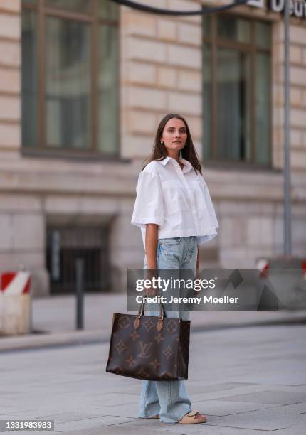 Toni wearing Soho Studios Blouse and Zara jeans with Louis Vuitton bag on July 30, 2021 in Hamburg, Germany.