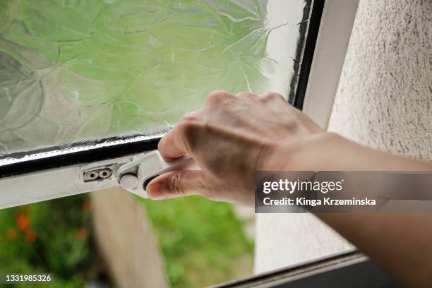 opening the window - haus einbruch stock-fotos und bilder