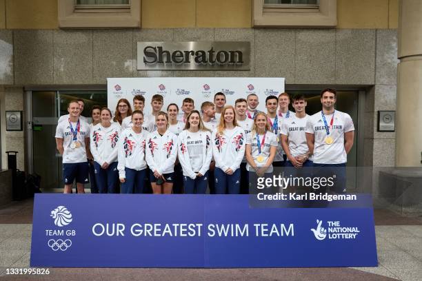 Team GB swimmers pose for a group photo during the National Lottery's event celebrating "our greatest swim team" at Sheraton Heathrow Hotel on August...