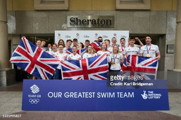Team GB swimmers pose for a group photo during the National Lottery's event celebrating "our greatest swim team" at Sheraton Heathrow Hotel on August...