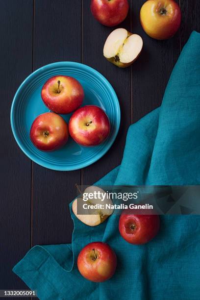 apples on blue plate - apple plate stock pictures, royalty-free photos & images