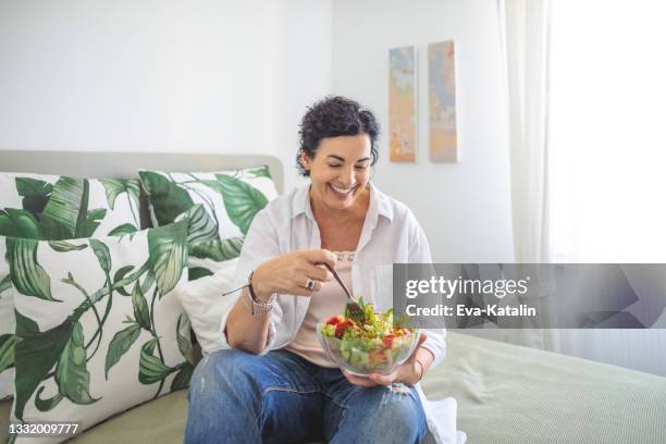 at home - mature women eating stock pictures, royalty-free photos & images