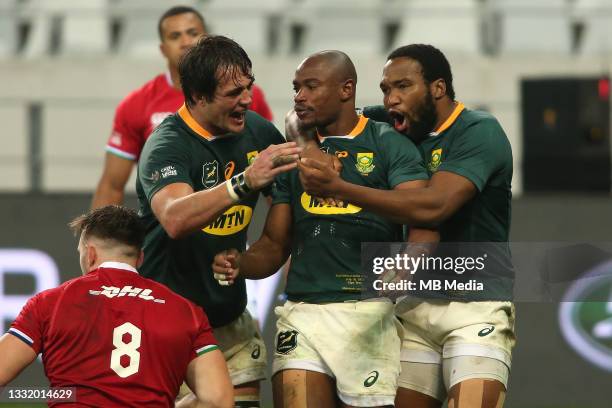 Makazole Mapimpi of South Africa is congratulated by his team-mates Franco Mostert and Lukhanyo Am after scoring a try during the second test between...