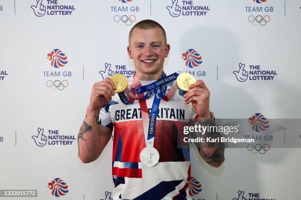 Adam Peaty poses for a photograph with his medals during the National Lottery's event celebrating "our greatest swim team" at Sheraton Heathrow Hotel...